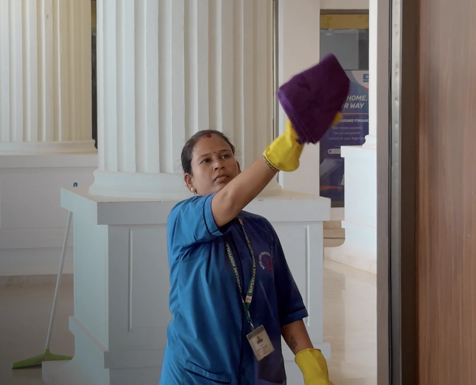 Uniformed Supercare team member carrying out detailed indoor service work at a client site in Bhopal