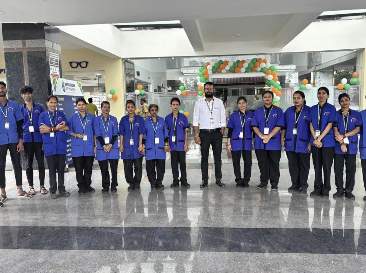 Supercare housekeeping team in blue uniforms lined up with a supervisor at Sewa Sadan Eye Hospital lobby