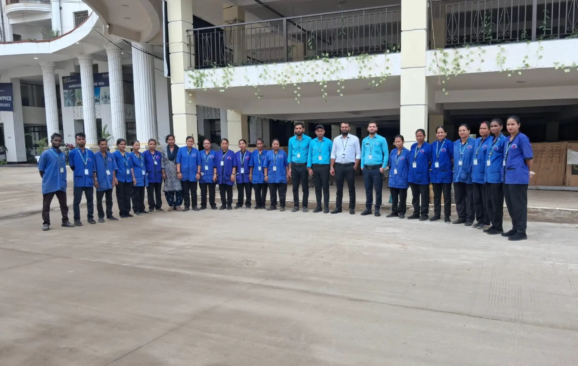 Large Supercare deployment of uniformed housekeeping and supervisory staff lined up outside a commercial building
